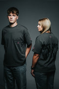 Two people wearing black t-shirts with text on a gray background