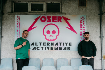 Two men standing in front of a 'Losser' alternative activewear sign on a wall.